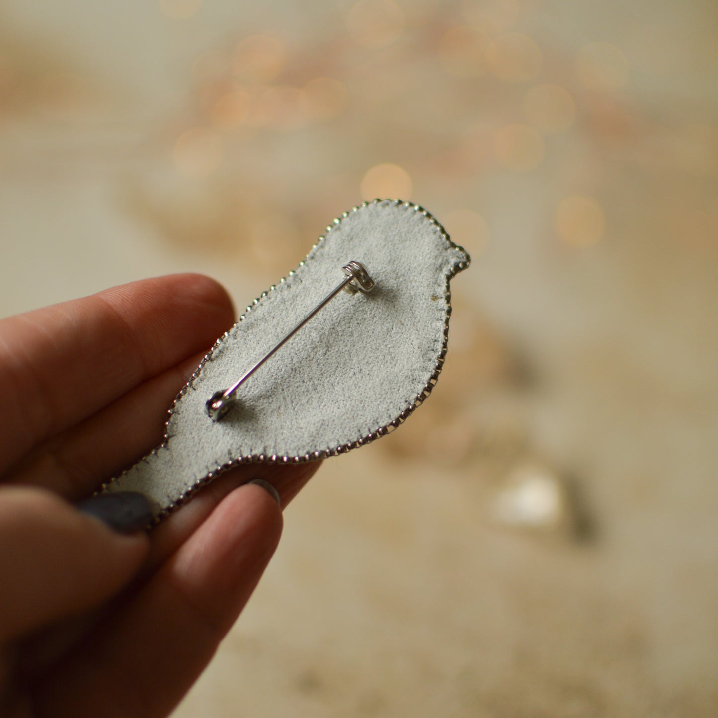 Silver sparrow beaded brooch back
