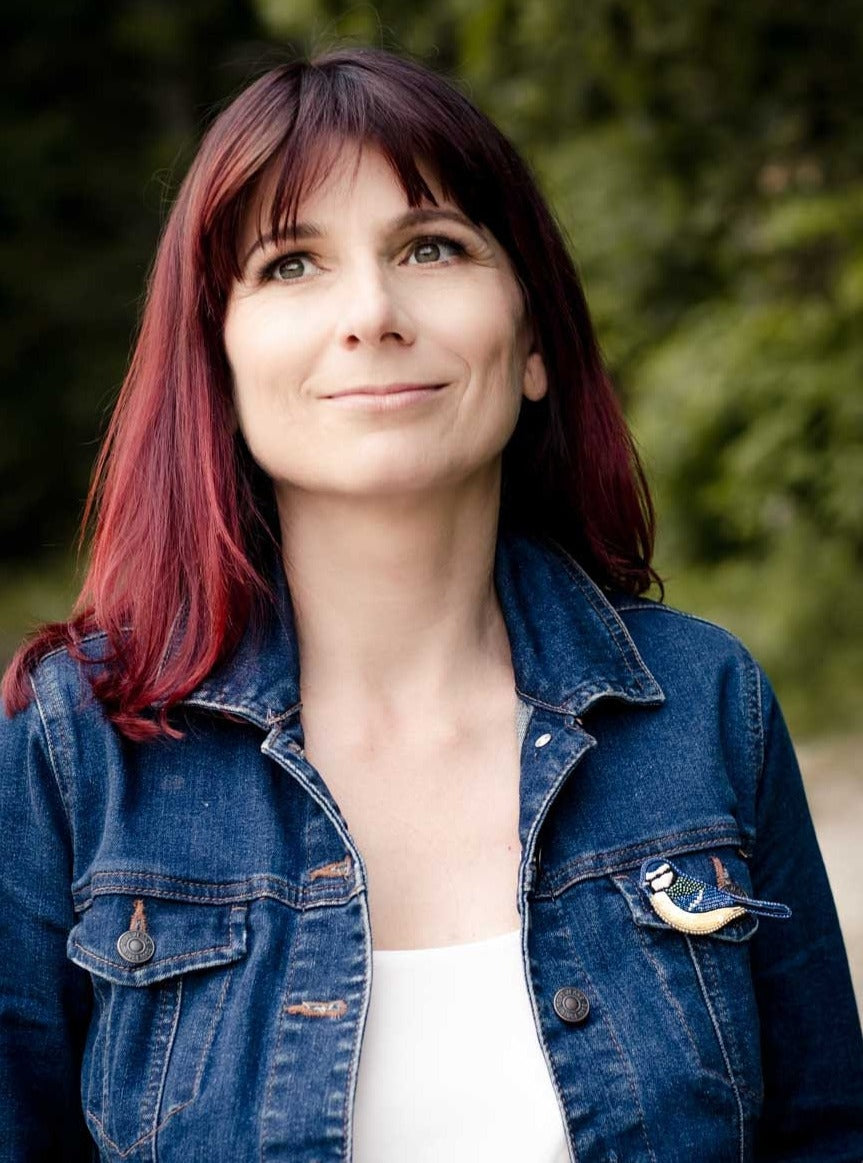 blue tit bead embroidered brooch worn on a jeans jacket