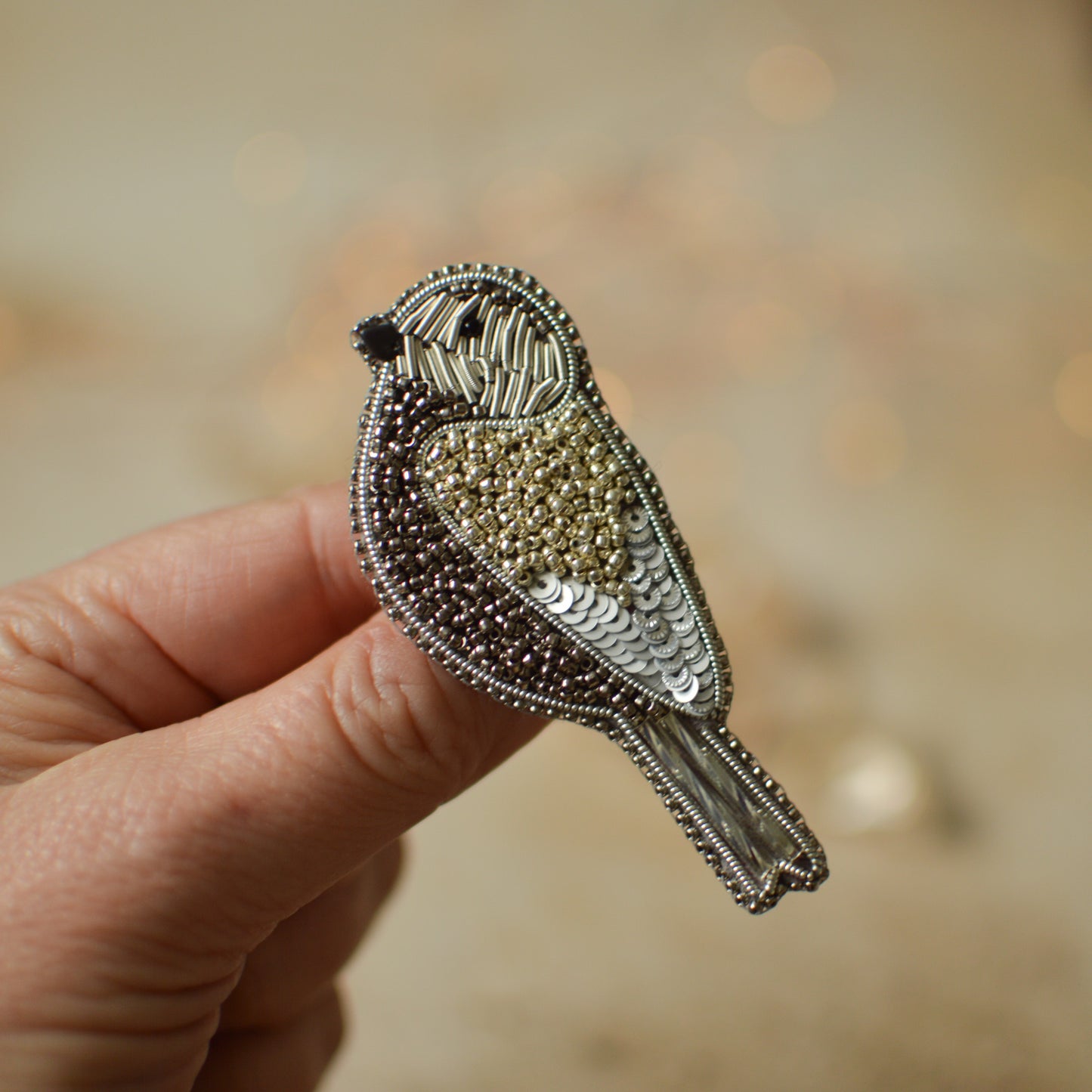 Silver sparrow beaded brooch