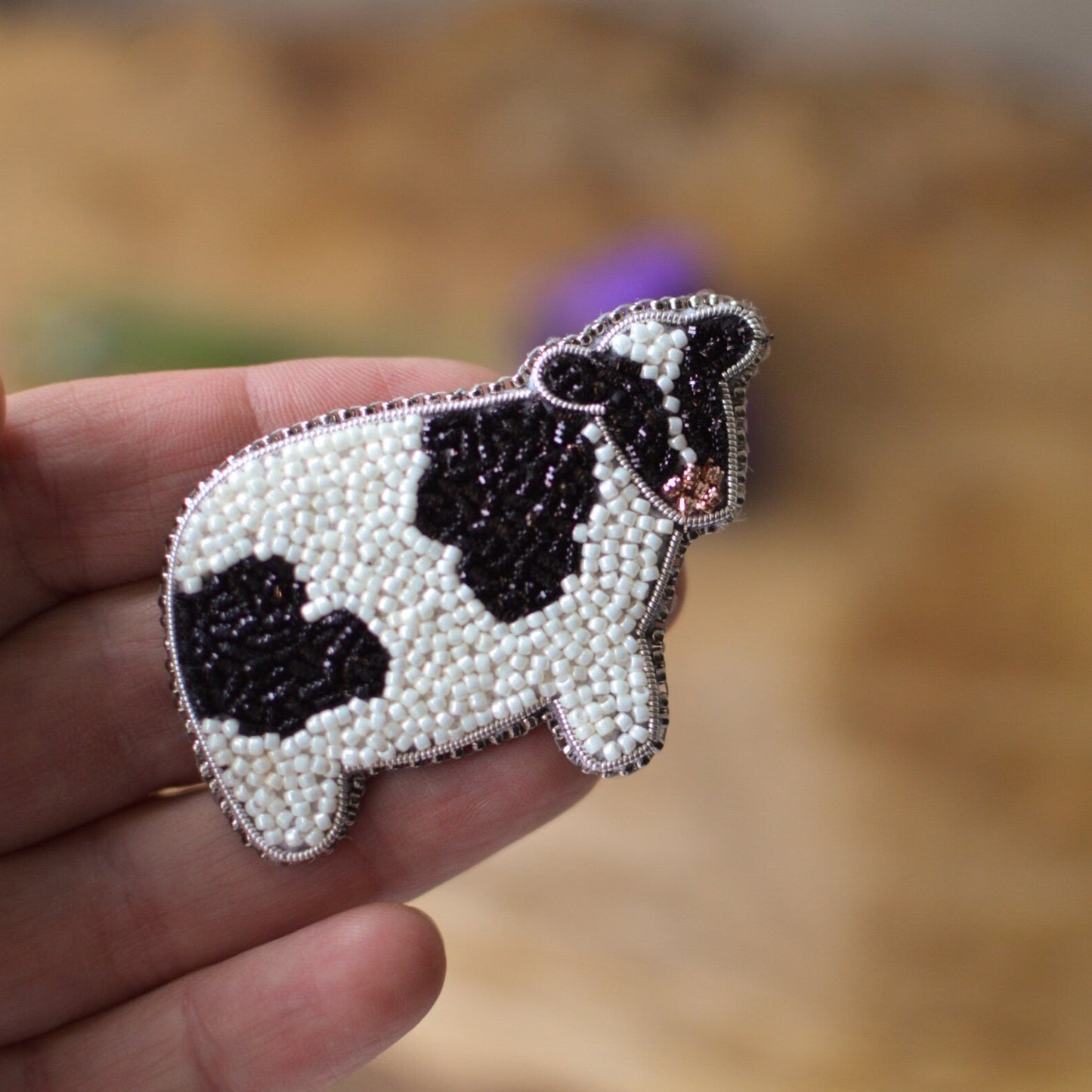 Black and white cow brooch