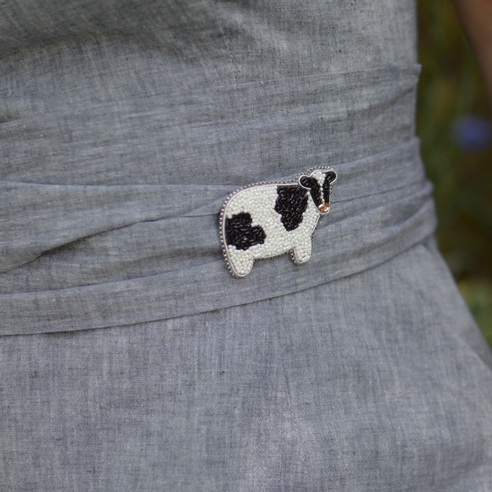 Farm cow brooch worn on a belt