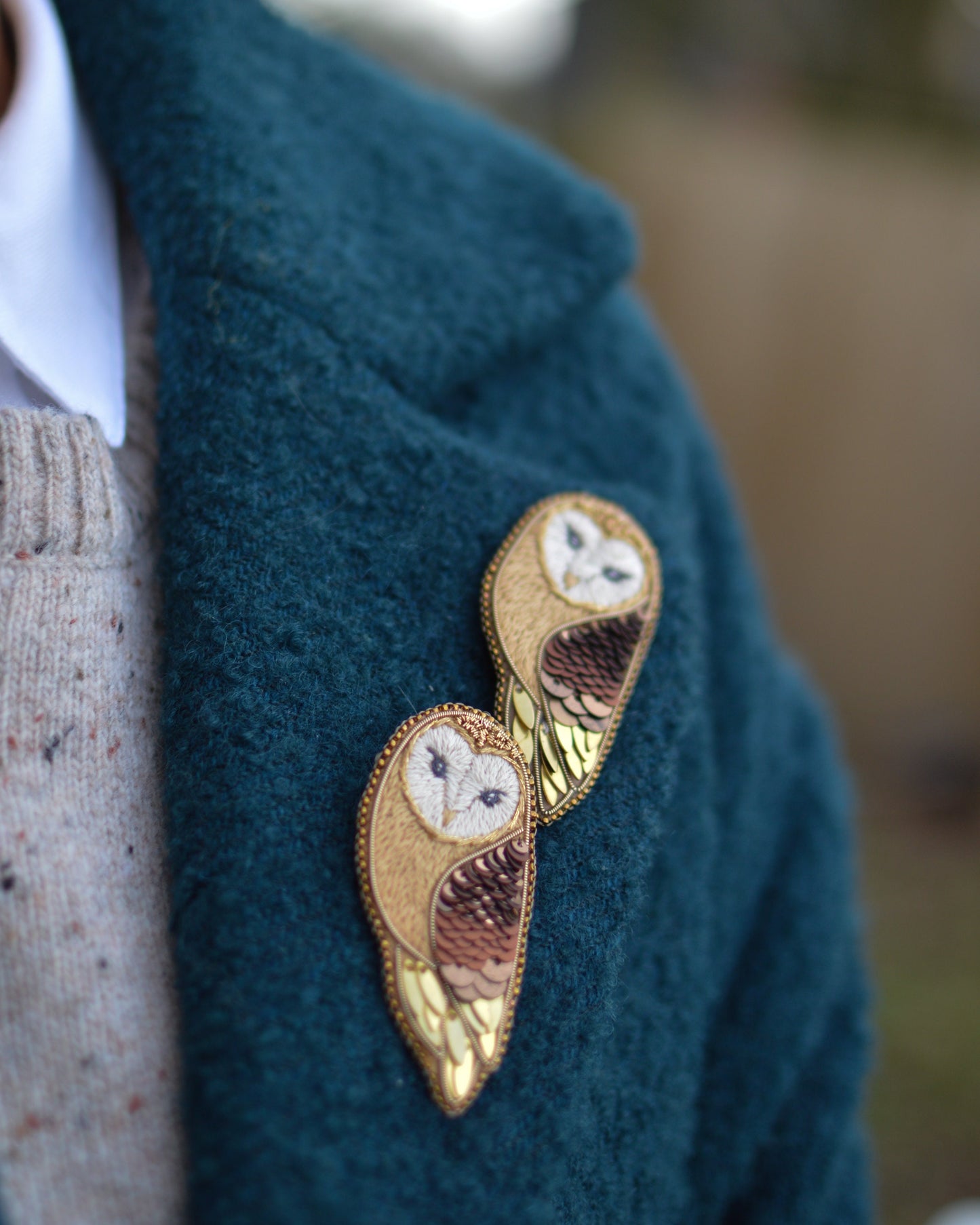 Barn Owl Brooches on a green coat lapel